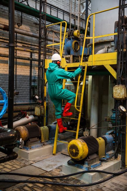 Site engineer wearing a hard hat at a petroleum facility